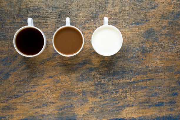 istock Three cups with coffee and milk on grunge background 803612854