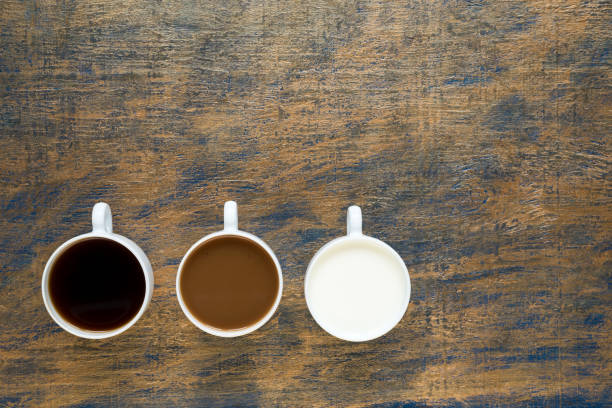 istock Three cups with coffee and milk on grunge background 803612898