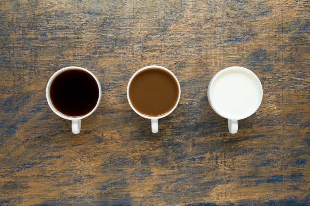 istock Three cups with coffee and milk on grunge background 803612920