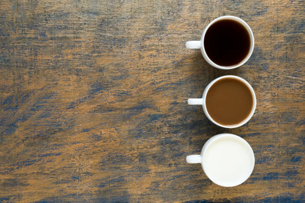 istock Three cups with coffee and milk on grunge background 803612944
