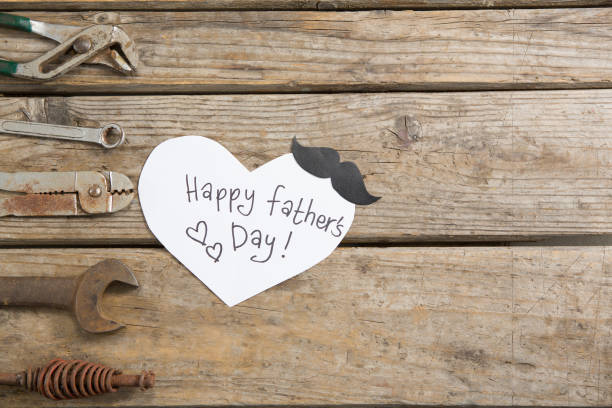 istock Overhead view of happy fathers day text by work tools 803631598