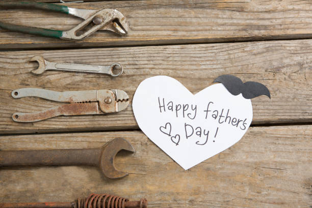 istock Overhead view of fathers day greeting card by work tools 803643892