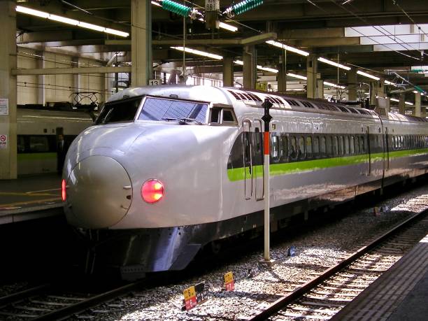 Shinkansen 2003 Japan, 2003.  This picture shows an older model Shinkansen at a station in Japan.  The red warning lights on this train indicate that this is its rear carriage.   mcdermp stock pictures, royalty-free photos & images
