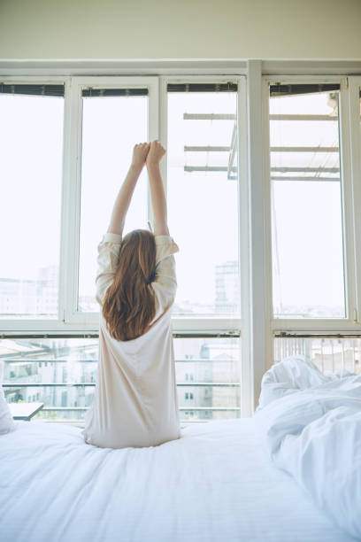 istock Woman stretching in bed 803650186