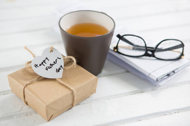 istock High angle view of coffee cup with fathers day gifts 803653884