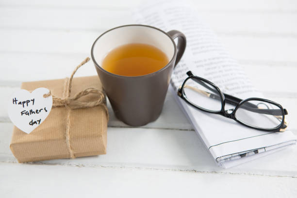 istock High angle view of coffee cup with fathers day gifts 803653964