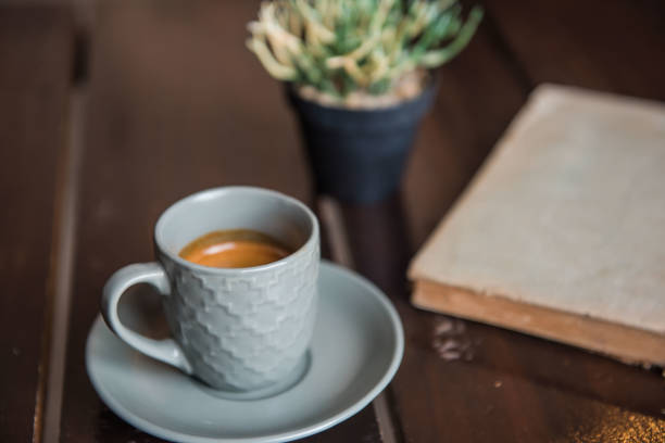 istock Cup coffee on White wooden table and old book and pot 803654150