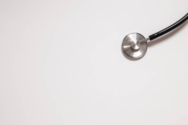 istock Close up view of black stethoscope on white back 803667198