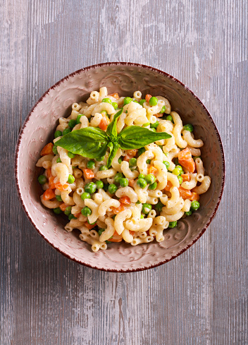 Creamy pea and carrot pasta in a bowl