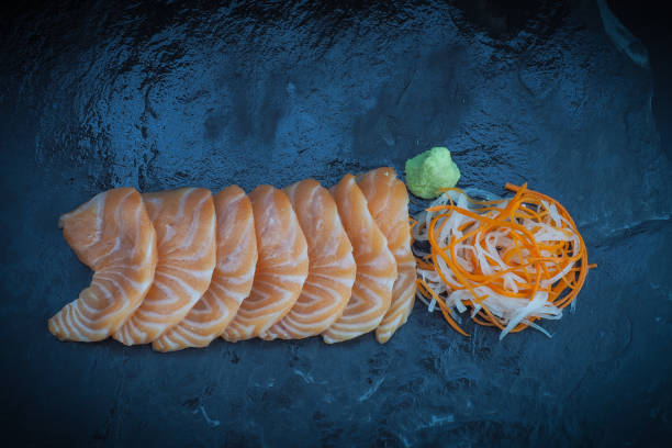 istock Salmon sashimi on black stone plate 803677654