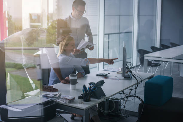 istock Business people using technology and having conversation. Business people at the office. 803686528