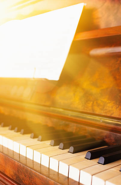 A nineteenth century German upright piano is bathed in mellow afternoon sunshine.