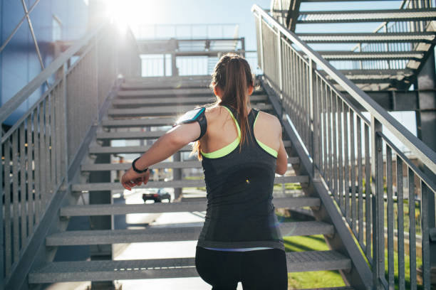 istock Woman running up a staircase 803690866