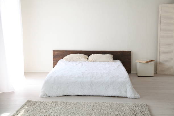 istock White bedroom bright interiors with bed 803693938