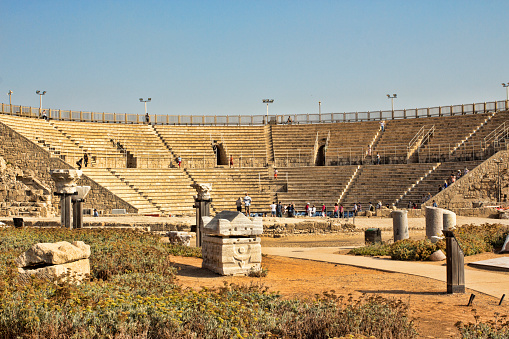 Caesarea, Israel - Oktober 28, 2016: Beautiful view of the Historical Roman amphitheater at Caesarea. Caesarea Maritima is an Israeli National Park in the Sharon plain, including the ancient remains of the coastal city of Caesarea. The city and harbor were built under Herod the Great during c. 22–10 BC near the site of a former Phoenician naval station known as Stratonos pyrgos. It later became the provincial capital of Roman Judea, Roman Syria Palaestina and Byzantine Palaestina Prima provinces.