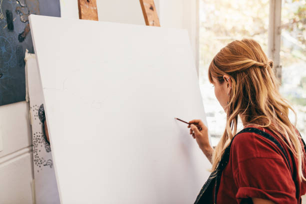 istock Female artist drawing on canvas 803698818