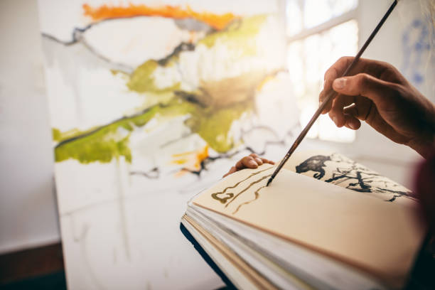 istock Female artist drawing pictures in book 803698930