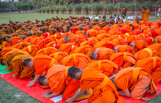 an unidentified group of monks praying in sarnath, india on 22 march 2015