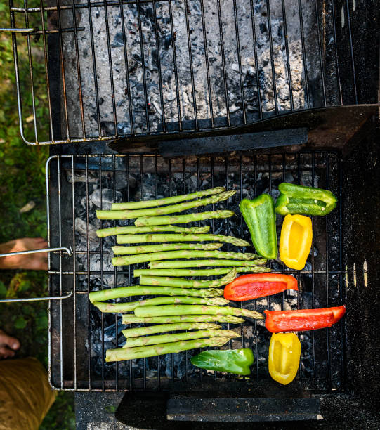 istock Asparagus and bell peppers on a barbecue bbq charcoal grill. 803699772