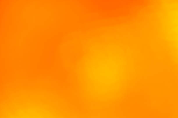 istock Orange abstract blur background with lens flare 803703236