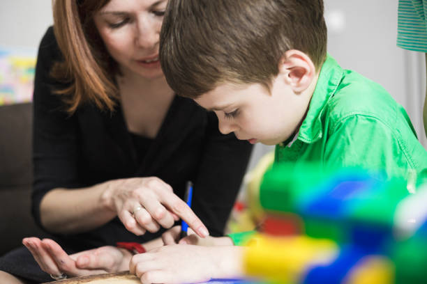istock Happy mother and son learning together 803707756