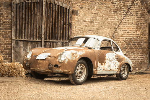 Classic 1950s Porsche 356 sports car barn find with a lot of patina on the body. This Porsche 356 A T1 Coupe 'Alaska' 1956 is in running condition. The car is on display during 2016 Classic Days at Dyck castle in Germany.