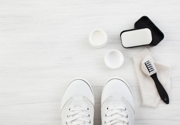 istock White sneakers and cream with brush and sponge 803716816