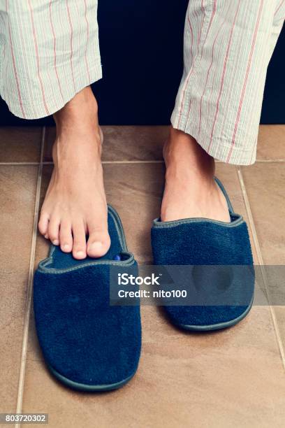 Young Man Putting On Or Off His Slippers Stock Photo - Download Image Now - Slipper, Men, Fluffy