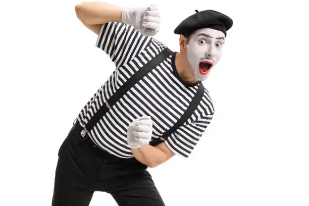 Mime behind an imaginary panel isolated on white background