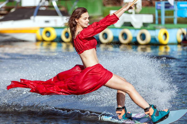 istock Woman in a red dress does not wakeboard. 803725970