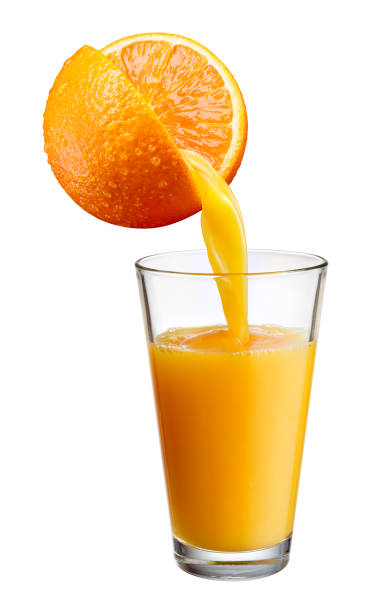istock Fresh juice pours from orange fruit into the glass isolated on white background. 803731784