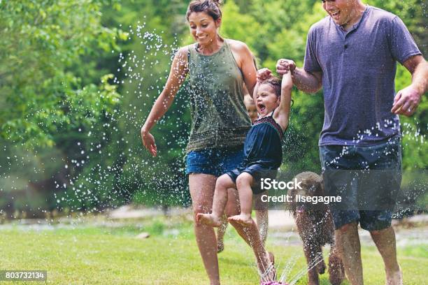 Millennial Parents Stock Photo - Download Image Now - Family, Sprinkler, Dog