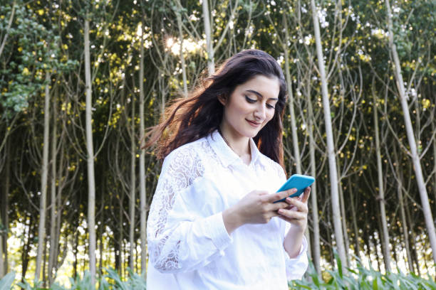 istock Girl using phone in the forest 803742718