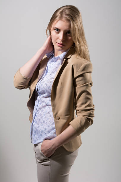 istock Beautiful young blonde in a light beige jacket 803748286