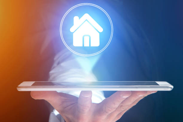 istock Businessman hand holding tablet with home icon 803748398