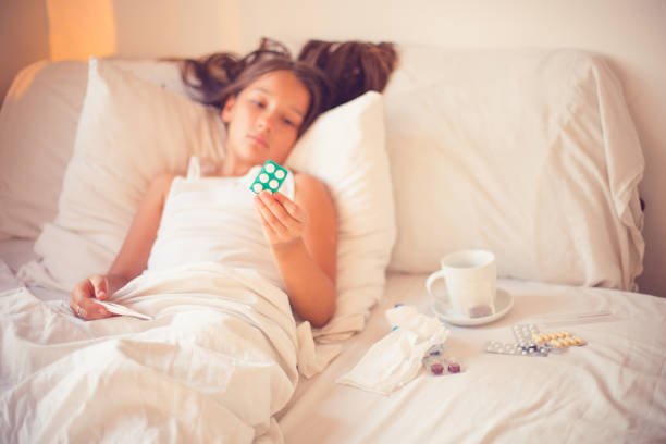 istock Sick little girl in bed. 803749028