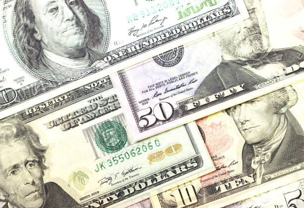 istock Abstract dollar bills of different denominations background. 803749546