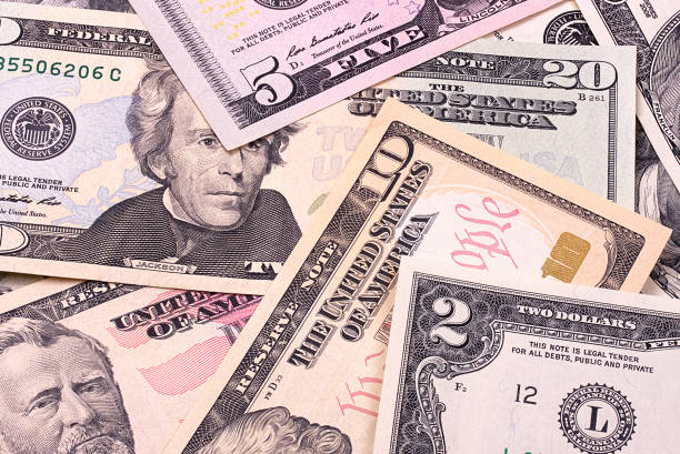 istock Abstract dollar bills of different denominations background. 803752470