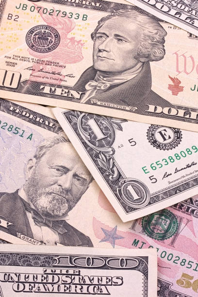 istock Abstract dollar bills of different denominations background. 803757546