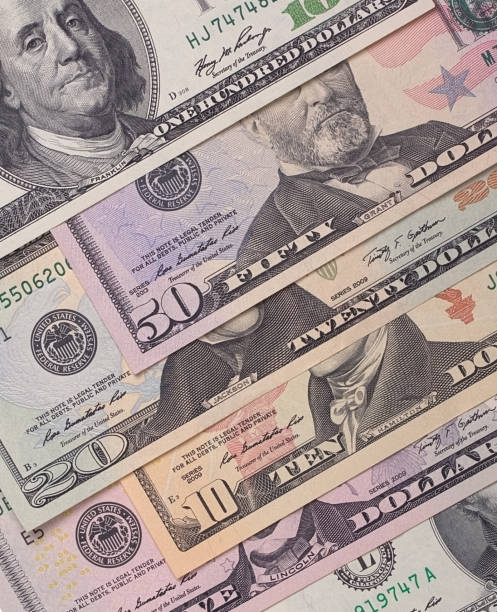 istock Abstract dollar bills of different denominations background. 803763638