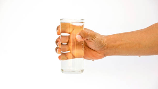 istock Man holding a glass of water on white background. 803770076