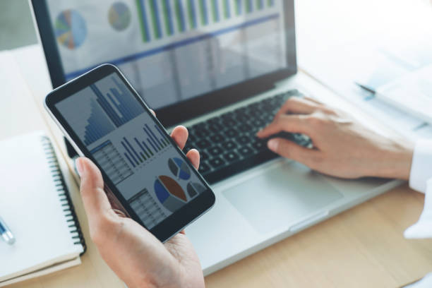 istock Businesswoman use computer and mobile phone to analyse online information. 803789436