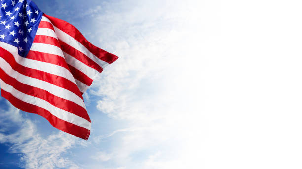 istock USA flag and blue sky with cloud background 803805556
