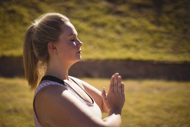 istock Beautiful woman praising yoga during obstacle course 803809022