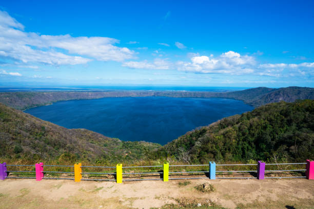 Protection fence at Laguna Apoyo view point in Nicaragua. Colorful and strong protection fence at view point of Laguna Apoyo, which is located in between volcano Masaya and town of Granada ion Nicaragua. Lake or Laguna Apoyo has many activities such as swimming, kayaking, hiking, scuba diving, birdwatching, paragliding, boating and horseback riding.  It is protected Natural Reserve, a volcanic lake. masaya volcano stock pictures, royalty-free photos & images