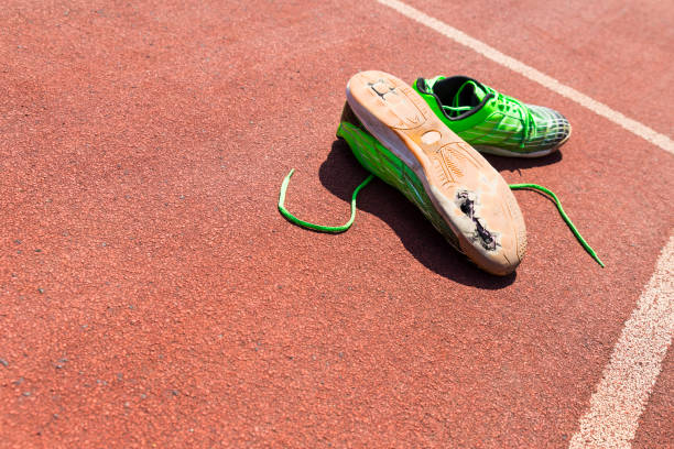 broken green running shoes stock photo