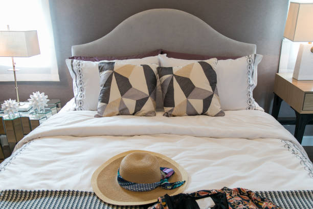 istock Women's hats and pillows on the bed. 803816272