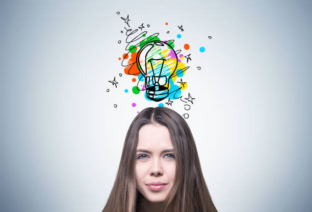 istock Young girl and colorful light bulb 803829254