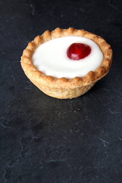 istock Cherry bakewell tart on dark background 803834128