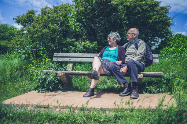 istock Senior couple relaxing on bench in nature 803842140